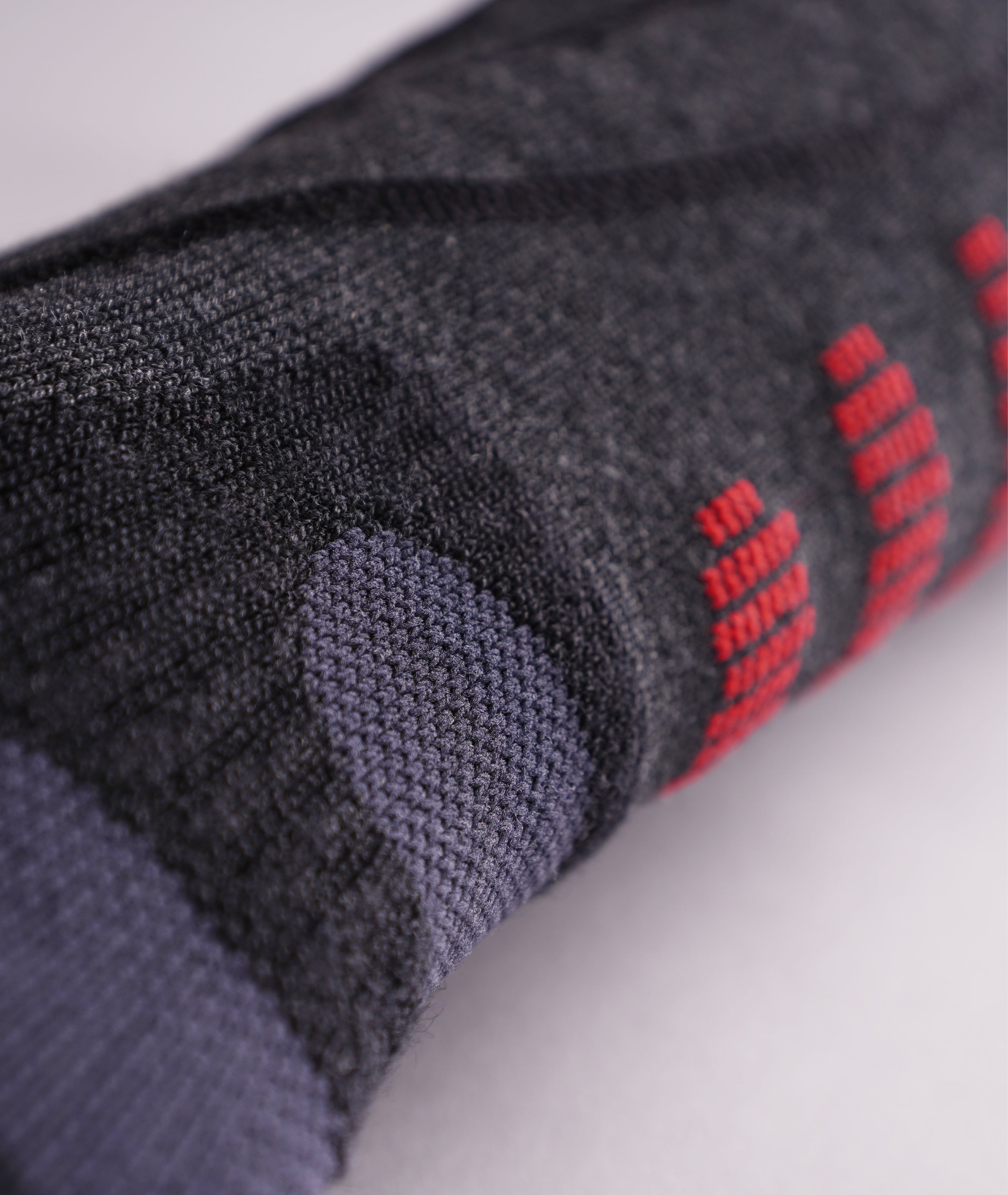 Black LENZ Heat Sock 6.1 heated ski sock heel and ankle with red toe edge, close-up