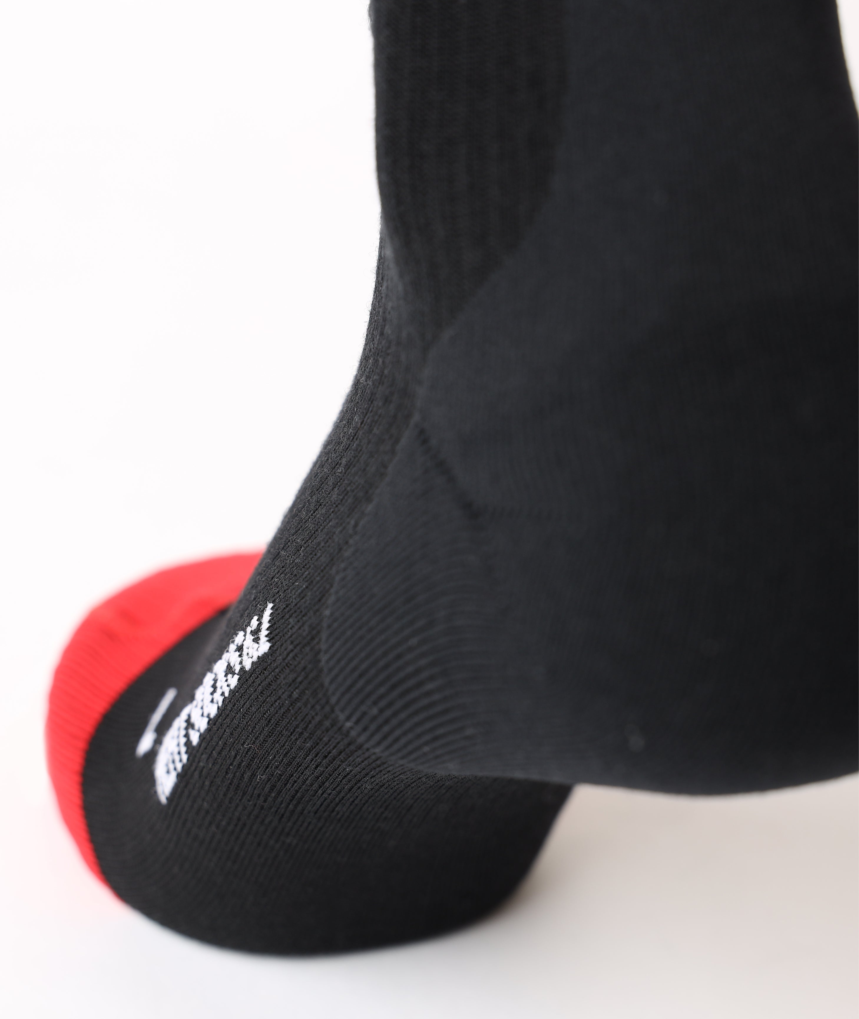 Close-up shot highlighting the ergonomically cushioned heel pocket on the black Lenz compression sock