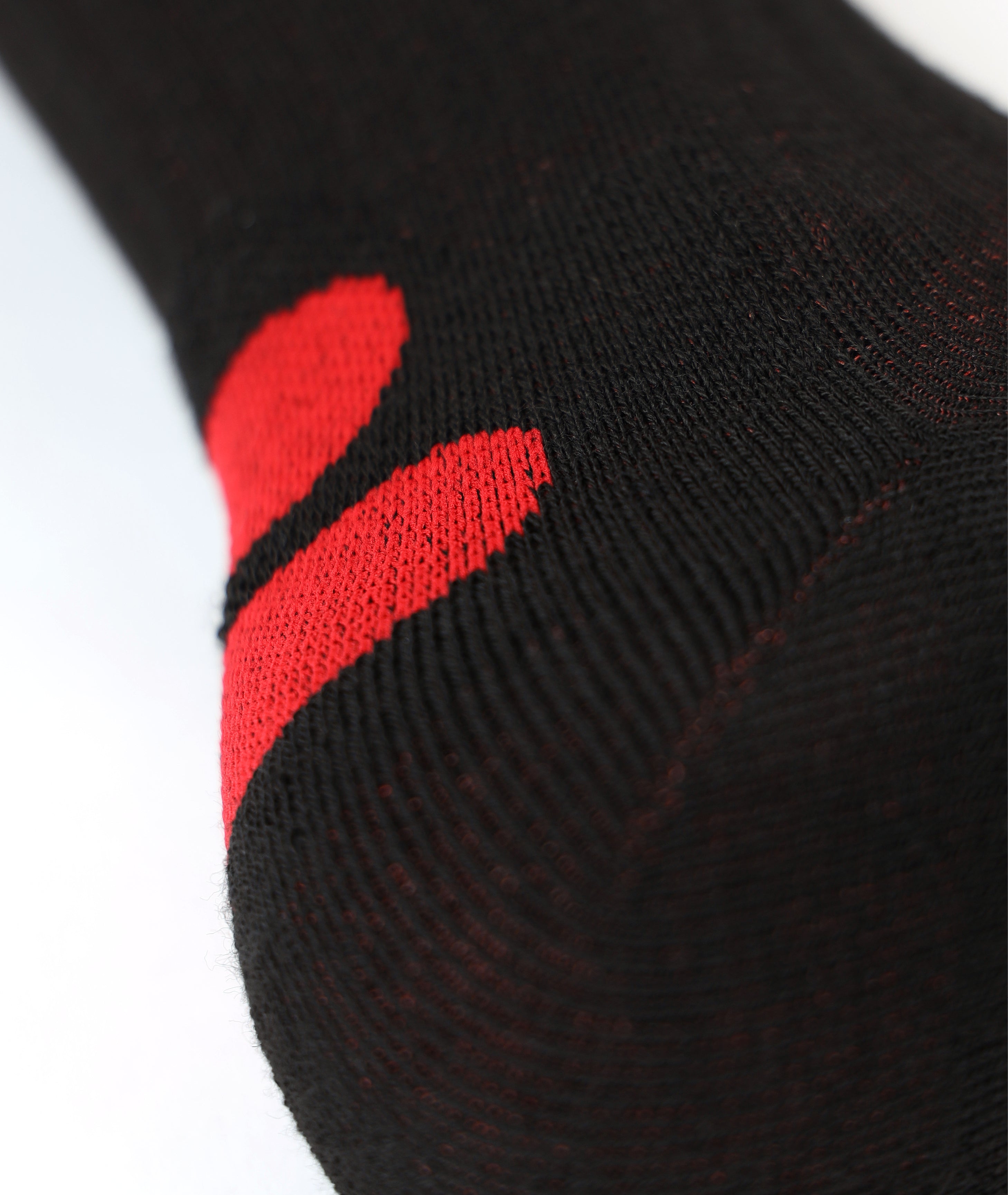 Close-up of the black LENZ Heat Sock 4.1 knit with red detailing