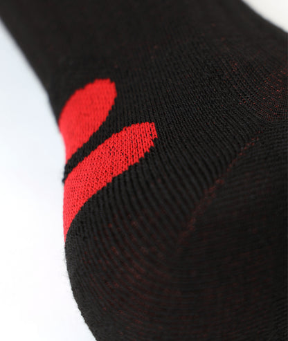 Close-up of the black LENZ Heat Sock 4.1 knit with red detailing