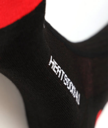 Close-up of the black LENZ Heat Sock 4.1 ankle showing the HEATSOCKS 4.1 branding