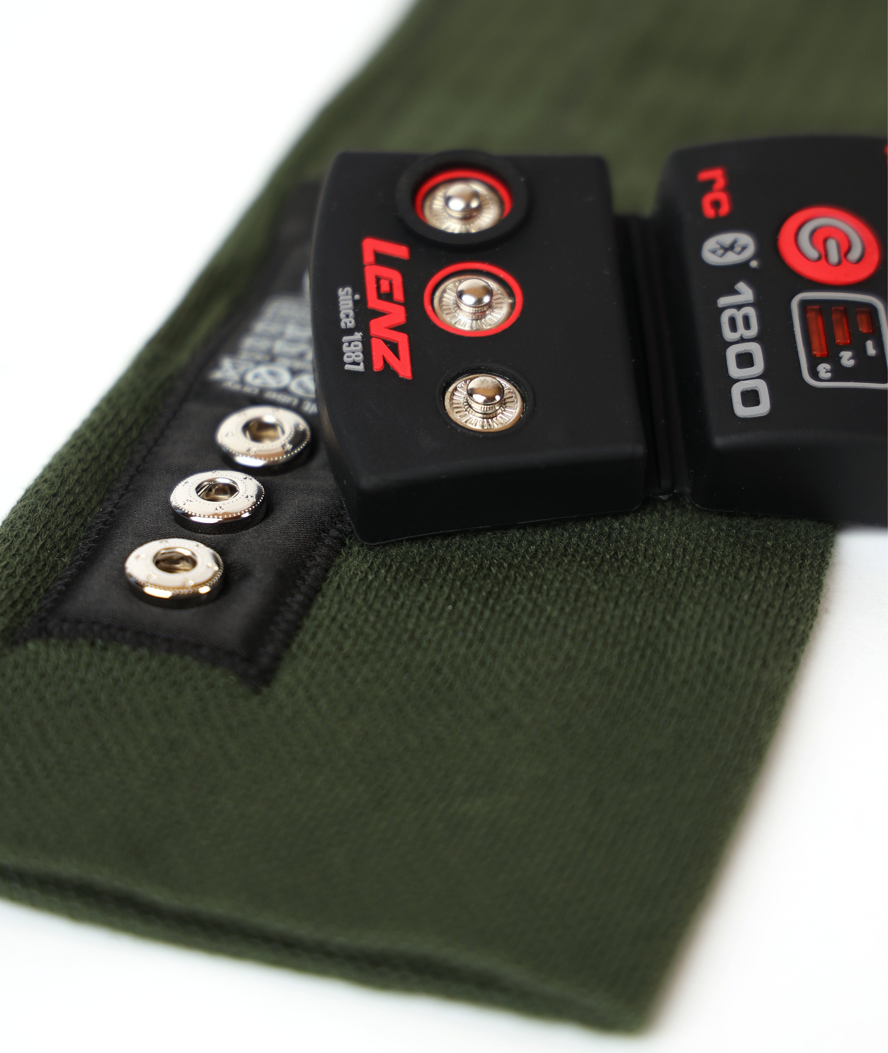 Olive LENZ Heat Sock 4.1 cuff with the black LENZ rcB 1800 heating controller attached by snap buttons