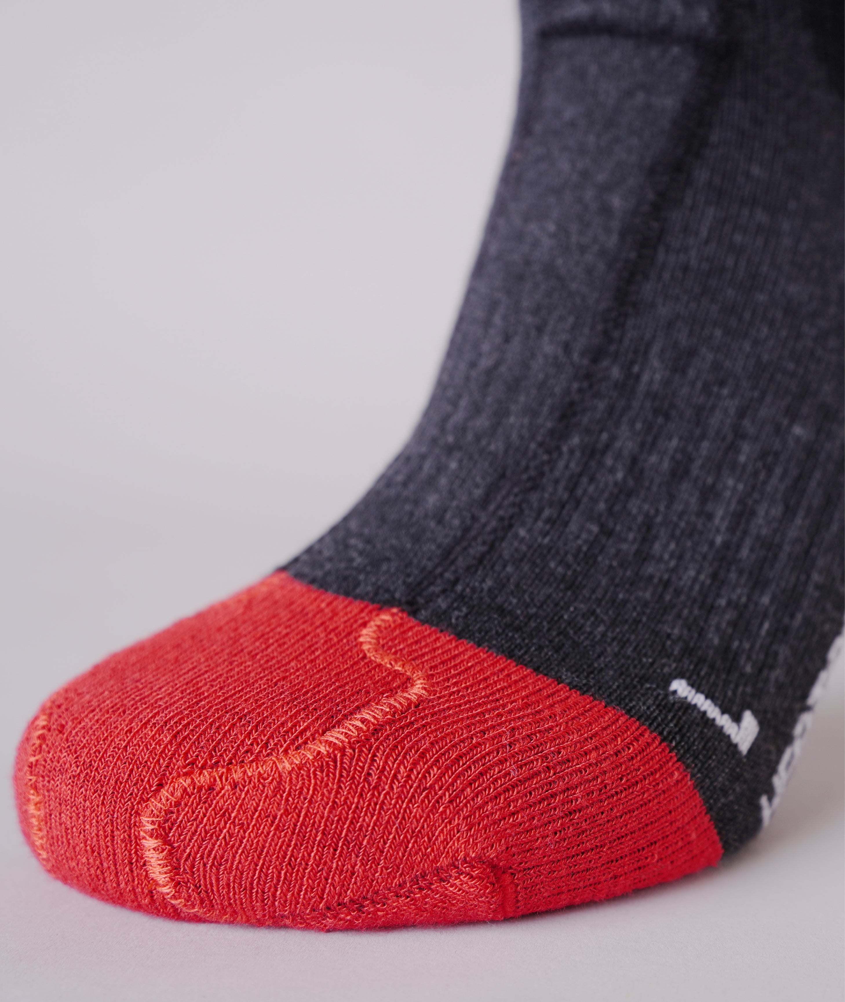 Black LENZ Heat Sock 6.1 heated ski sock cuff with red LENZ logo and branding, close-up