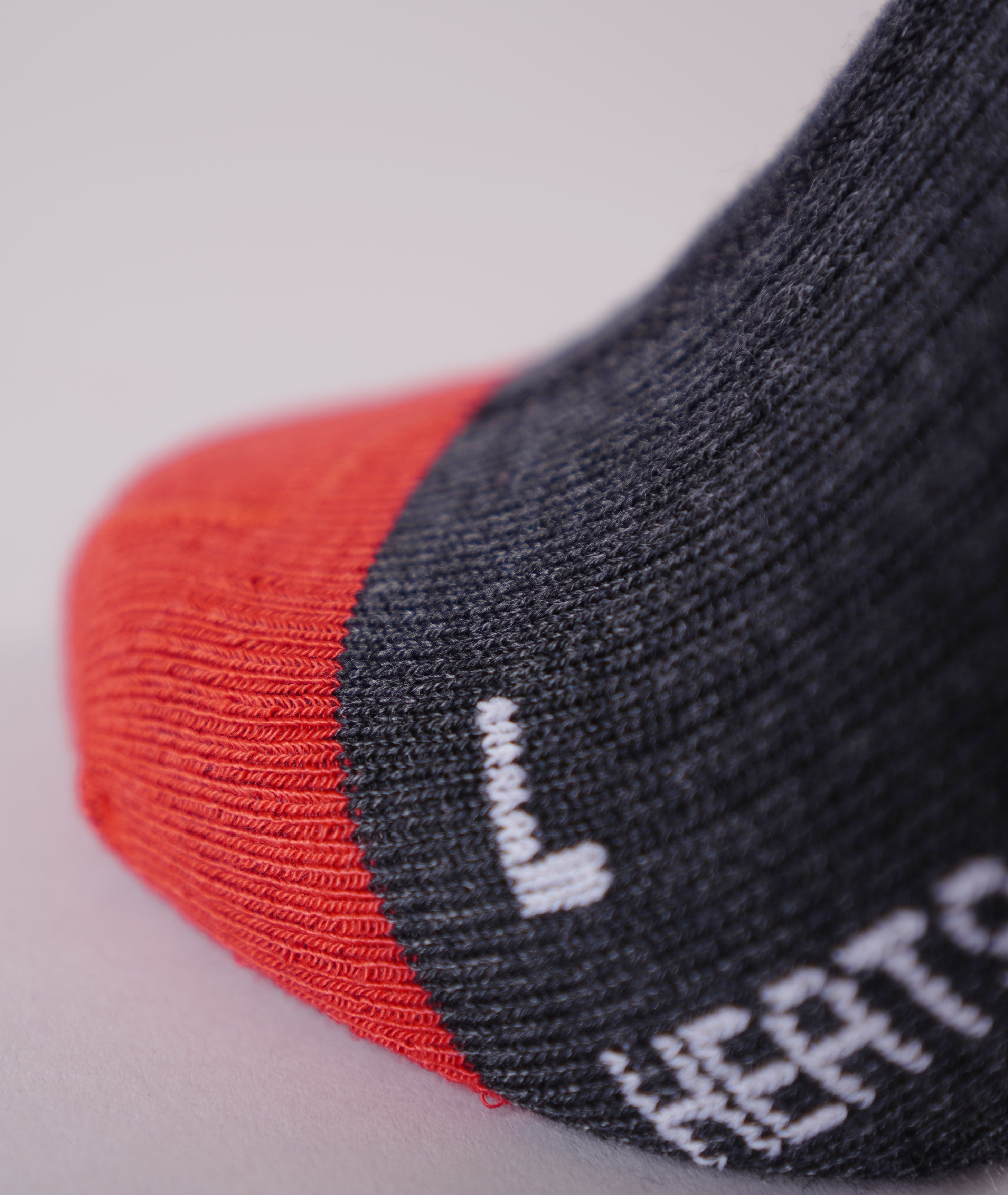Black LENZ Heat Sock 6.1 heated ski sock cuff press studs with LENZ rc 1800 lithium battery pack, close-up