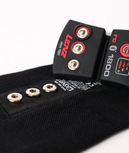 Close-up detail of the metal snap connectors and cuff bracket designed to secure the Lenz lithium battery pack