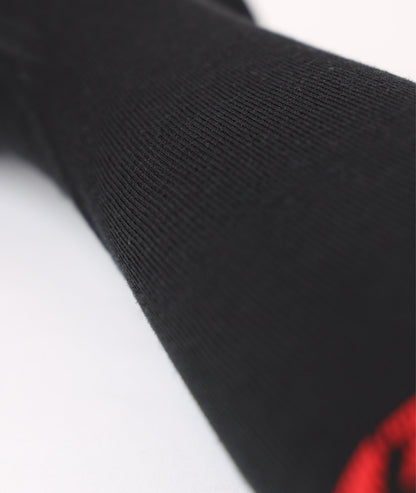 Extreme close-up showing the knit pattern and premium elastic compression fabric texture of the black Lenz ski sock