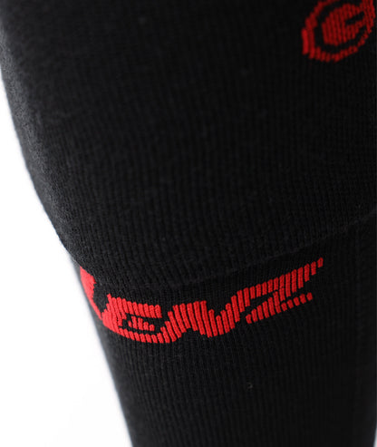 Close-up of the upper leg on the black Lenz heat sock 6.1, showcasing the red knit Lenz branding logo