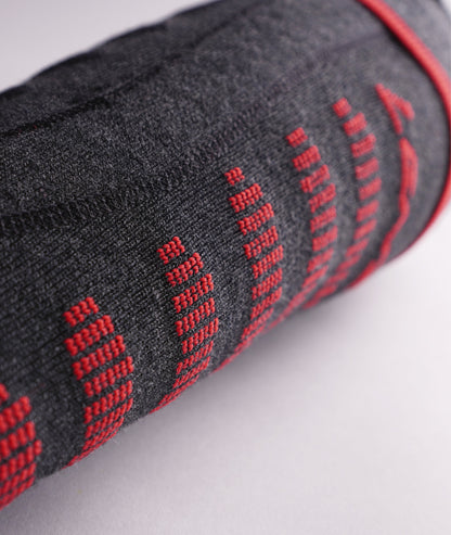 Detailed macro shot of the grey knit fabric texture and red vertical stitching lines on the Lenz 6.1 sock