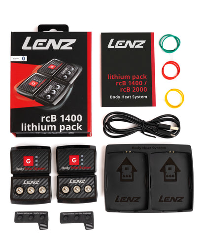 LENZ rcB 1400 lithium pack kit contents, two battery packs, twin cradle, USB cable, manual and coloured marker rings, flat lay
