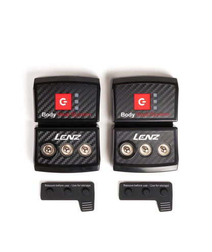 Two black LENZ rcB 1400 battery packs showing press-stud connectors with storage caps set below, top view