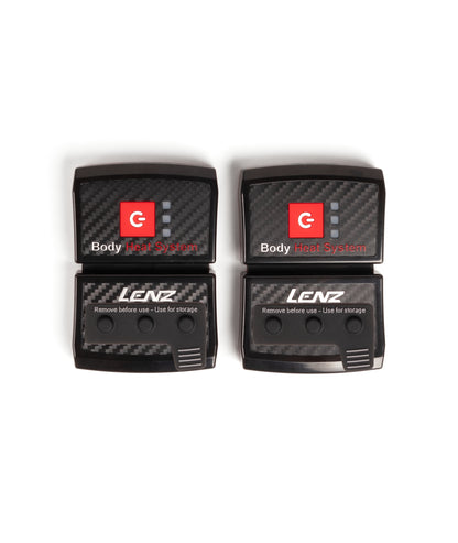 Two black LENZ rcB 1400 battery packs, Body Heat System fronts with power buttons and separate storage caps, top view