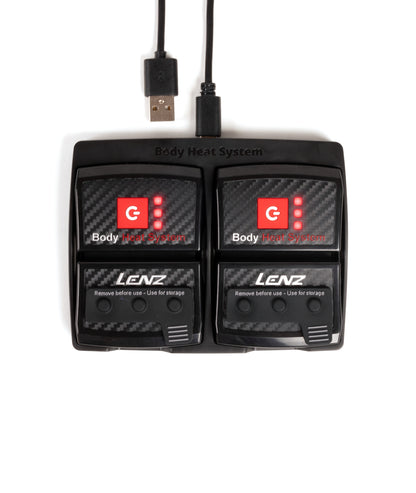 Two black LENZ rcB 1400 battery packs with red power buttons and lit LED levels, USB cable, top view